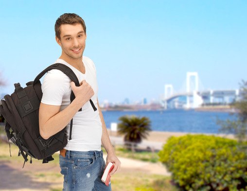 travelling student with backpack and book